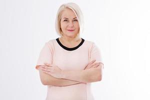 Elegant middle aged woman posing with pink dress over white photo