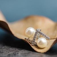 A beautiful Pearl Ear studs. Close-up of white pearl earrings. photo