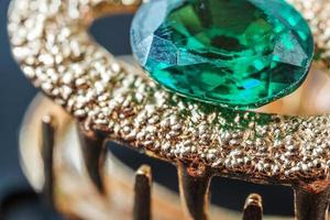 green natural gemstone, Gems or gems on shiny gold photo
