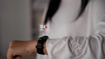 close-up fitness armband zijaanzicht van vrouw die knoppen op smart watch drukt en naar trainingsapparatuur kijkt app technologie monitor actieve gadget jogger tech. projecteren van zichtbaar ar scherm concept. video