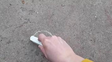 girl draws a heart with chalk on the chalkboard. love, romance. drawing, creativity video