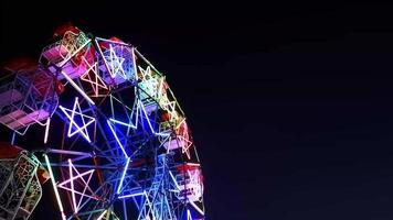 Low angle view of illuminated decorative lighting on ferris wheel in night sky background