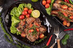 Pork steak topped with white sesame and fresh pepper seeds along. photo