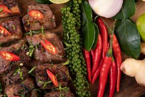 Pork steak topped with white sesame and fresh pepper seeds along. photo