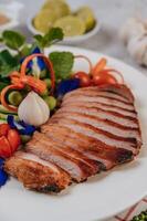 Pork with lemon, onion, red onion, tomato, long bean, butterfly pea flower, and mint. photo