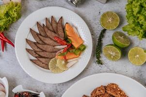 Grilled liver slices with carrots, chili, spring onions, and mint. photo