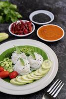Noodles in a banana leaf with beautifully laid vegetables and side dishes. Thai food. photo