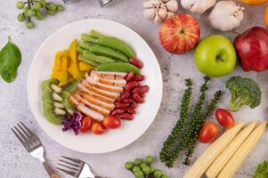 filete de pollo con guisantes, tomates, kiwi y calabaza. foto