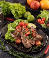 Pork steak topped with white sesame and fresh pepper seeds along. photo