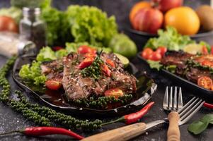 Pork steak topped with white sesame and fresh pepper seeds along. photo