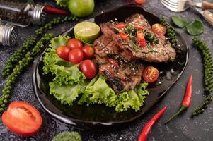 Pork steak topped with white sesame and fresh pepper seeds along. photo