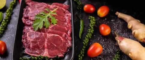 Pork used for cooking with chili, tomato, basil, and fresh pepper seeds. photo