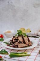 Grilled Liver Slices with, carrots, chili, spring onions, and mint. photo