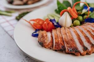 Sliced pork with lemon, red onion, tomato, long bean photo