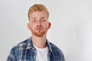 Close up portrait of sad red head man isolated on white background photo