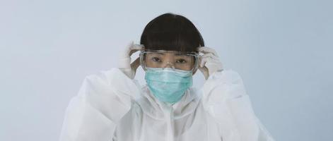 Doctor in PPE suit gesture make hand sign. Represent victory win over virus. photo