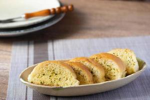 Slices of toasted bread with garlic and herbs photo