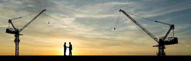 The silhouette of the crane in the construction site photo