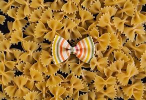 Mixed colorful farfalle pasta. Flat lay. Top view. photo