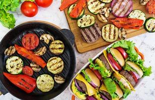 Grilled vegetables and handmade burger. Zucchini, eggplant, mushrooms, pepper on the grill. Top view photo