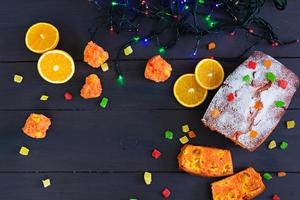 Cupcake with orange and dried apricots on Christmas background photo