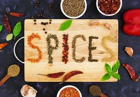 Different spices on dark background. Top view photo