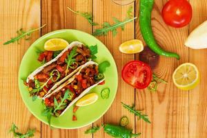Mexican tacos with beef in tomato sauce photo