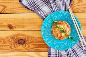 Tyahan with chicken and vegetables on wooden background photo