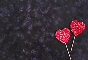 Colorful lollipops on dark background. Top view