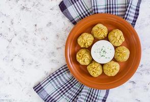 Delicious manti dumplings on white background photo