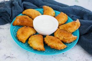 Baked dumplings on white background photo