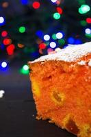 Cupcake with orange and dried apricots on Christmas background photo