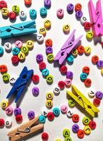 Colorful alphabet and number beads on white background photo