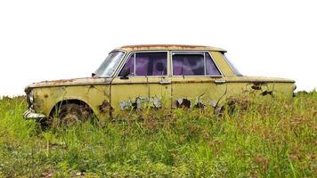 Isolate old saloon car in grass. photo