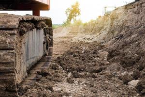 Backhoe wheel with soil. photo