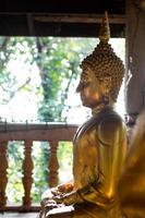 Old Buddha in the wooden pavilion. photo