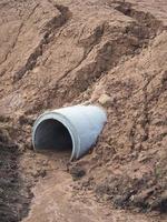 Concrete drainage pipes landfill cover soil. photo
