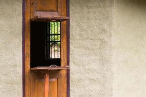 Wooden window opening with cement wall. photo
