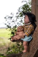 Group of baby dolls sitting on old wooden stairs. photo