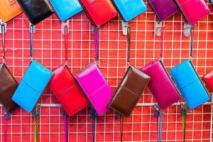 Colorful wallet hanging in rows. photo