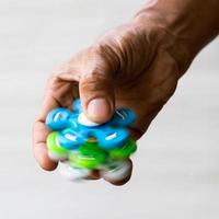 Colorful spinners in the fingers. photo