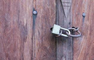 Lock key on old wooden door. photo