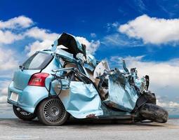 Car demolished with sky clouds. photo