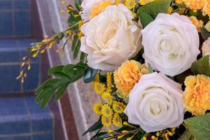 Close up of fake white and yellow roses bouquet. photo