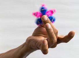 Hand star spinner in fingers. photo