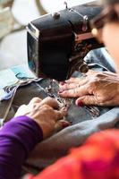 Female sewing repair jeans.