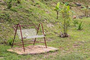 White Swing bench in the garden. photo