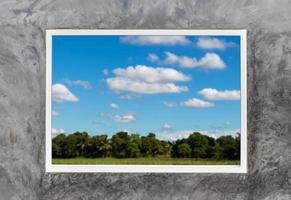 White window frames in concrete with rural sky clouds. photo