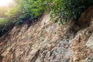 Surface rocky cliffs with weeds. photo