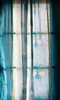 Flower pattern curtains with dark window. photo